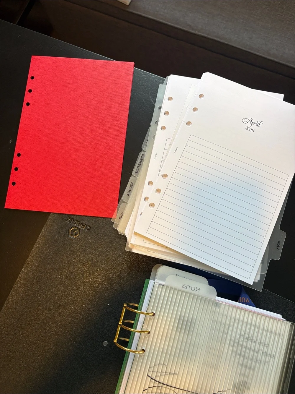 A5 Planner Pages with Blue Ribbon and Gold Rings.
